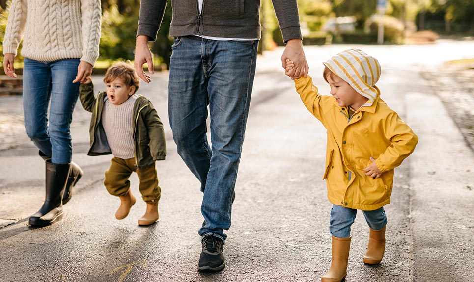 A young family walking in their neighborhood