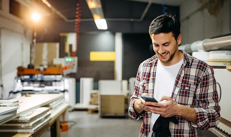 Young business owner checking his smartphone