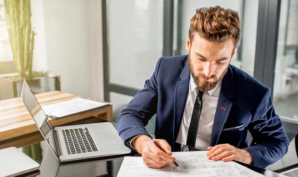 Business man going over financials in his office