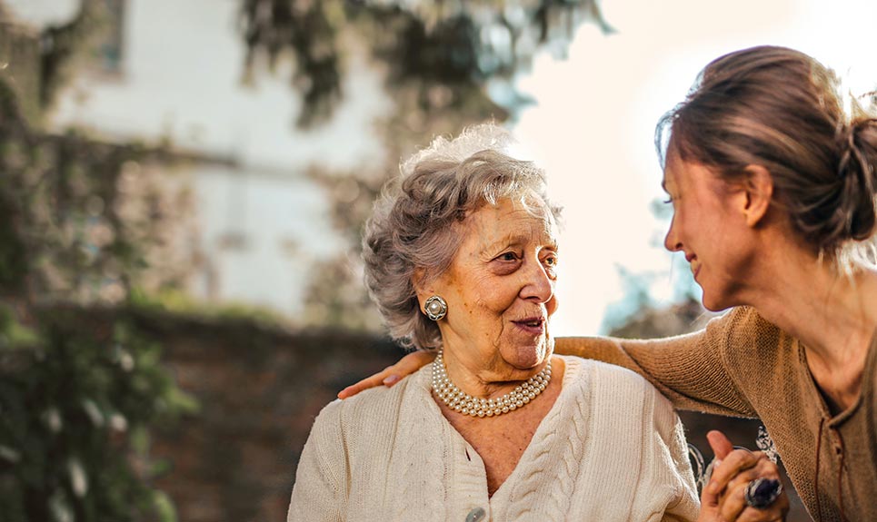 A elderly lady talking with a younger lady