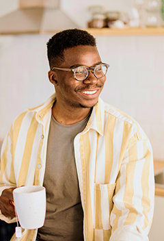 Young man drinking coffee in his kitchen