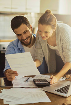 Young couple going over finances in their kitchen